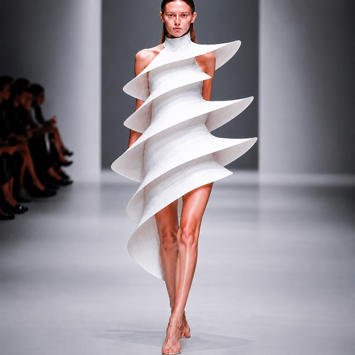 White sculptural runway dress using punch-card textile language